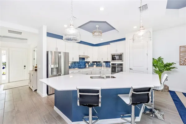 a kitchen with stainless steel appliances white cabinets and a stove