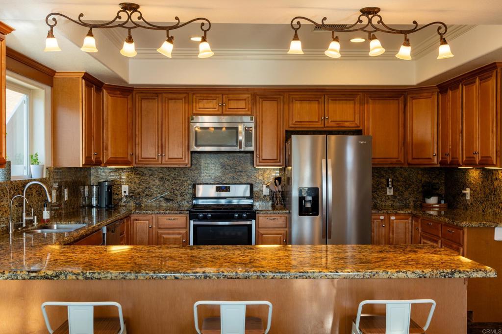 1657 Coronado Avenue Spring Valley, CA 91977 - Photo 11 of 46 a kitchen with stainless steel appliances granite countertop a sink a stove and refrigerator