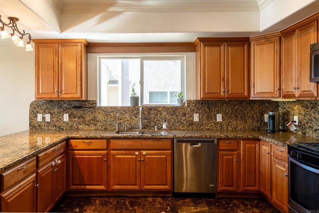 1657 Coronado Avenue Spring Valley, CA 91977 - Photo 12 of 46 a kitchen with granite countertop a sink and a stove