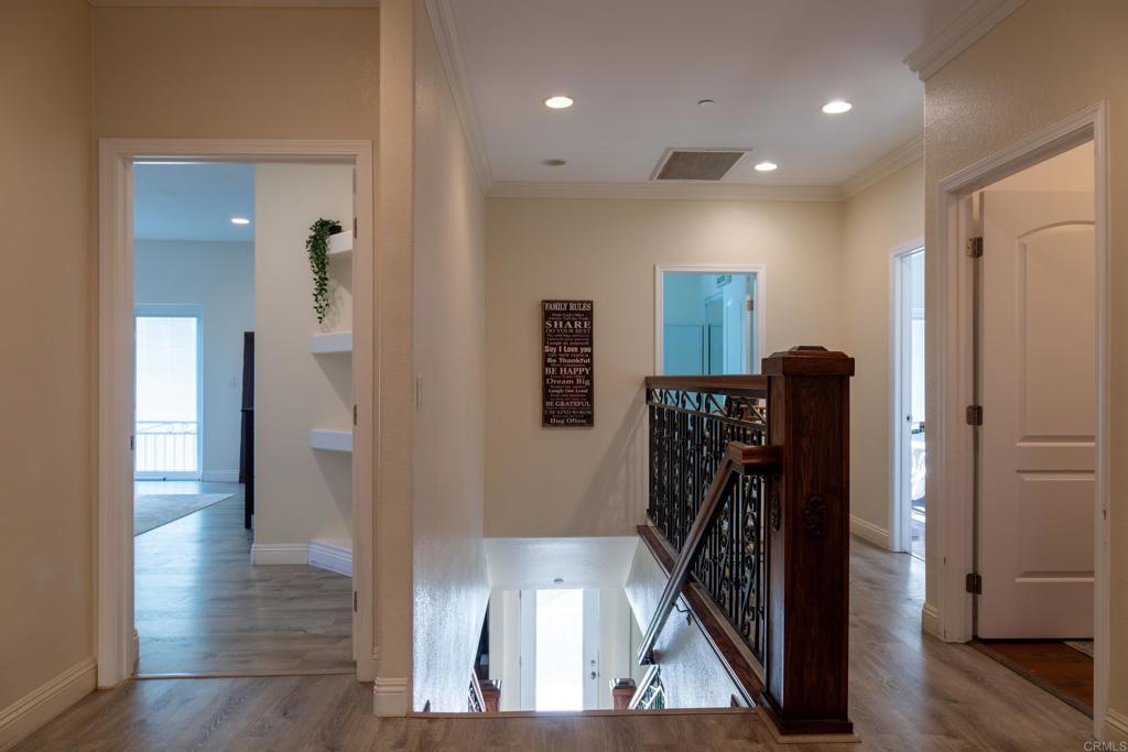 1657 Coronado Avenue Spring Valley, CA 91977 - Photo 13 of 46 a view of a hallway with wooden floor and stairs