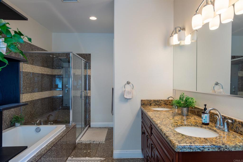 1657 Coronado Avenue Spring Valley, CA 91977 - Photo 18 of 46 a bathroom with a granite countertop sink a mirror and a shower
