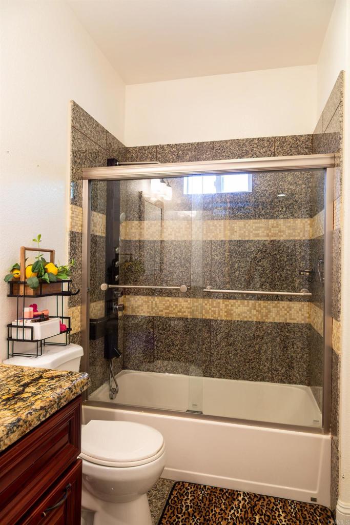 1657 Coronado Avenue Spring Valley, CA 91977 - Photo 28 of 46 a bathroom with a granite countertop sink mirror vanity and toilet