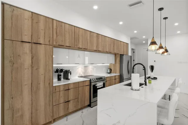 a kitchen with a sink cabinets and appliances