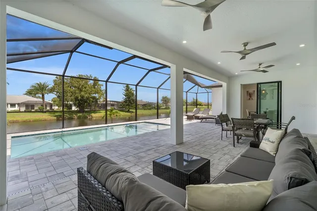 a swimming pool with outdoor seating and yard