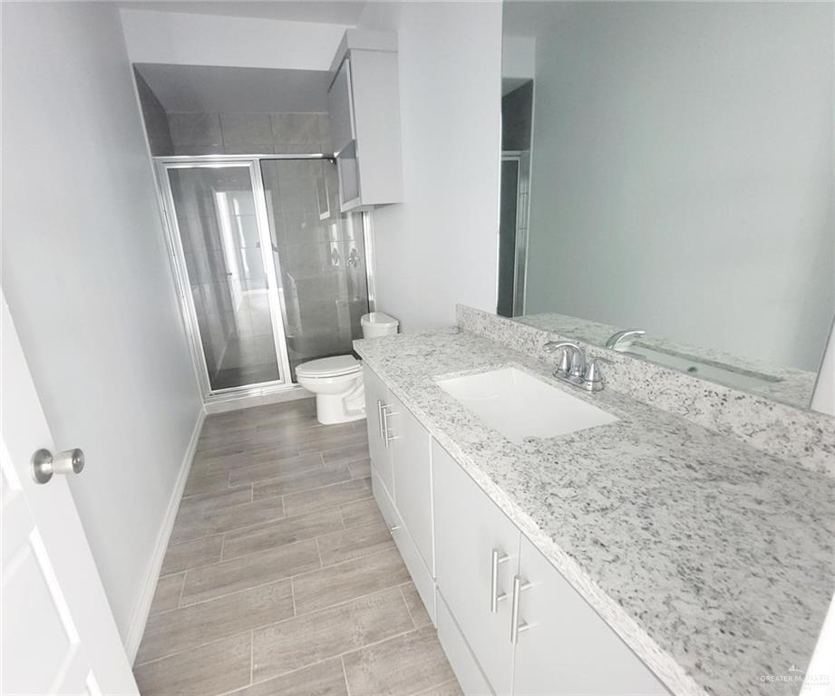 2808 Rosemary Drive, Unit 1 Weslaco, TX 78599 - Photo 12 of 13 a bathroom with a granite countertop sink and a mirror