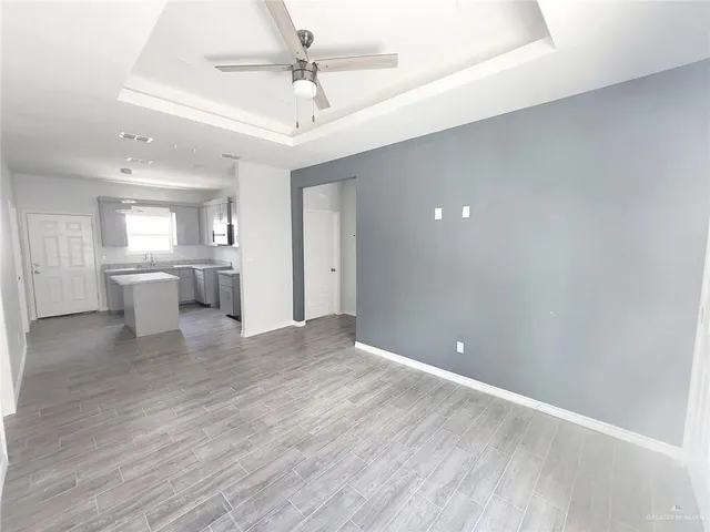 a view of a kitchen with a sink and a refrigerator