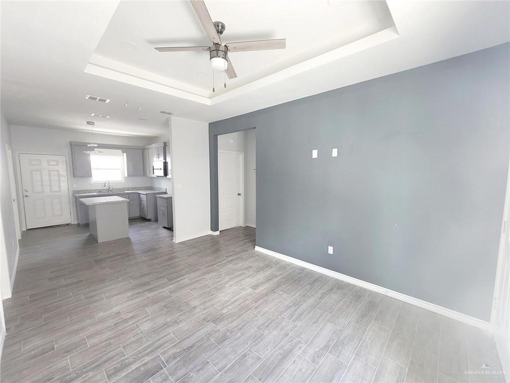 2808 Rosemary Drive, Unit 1 Weslaco, TX 78599 - Photo 4 of 13 a view of a kitchen with a sink and a refrigerator