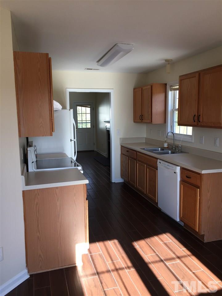 5405 Advantis Drive Raleigh, NC 27610 - Photo 6 of 16 a kitchen with stainless steel appliances granite countertop a stove a sink and a refrigerator