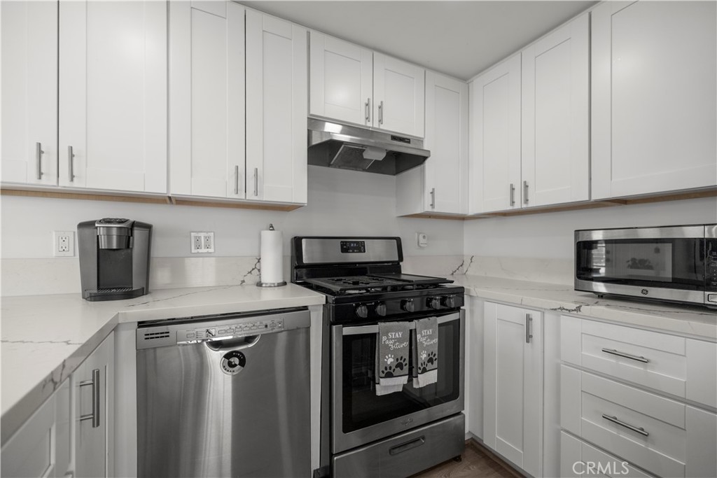 27150 Shadel Road, Unit 122 Menifee, CA 92586 - Photo 8 of 26 a kitchen with granite countertop cabinets and steel stainless steel appliances