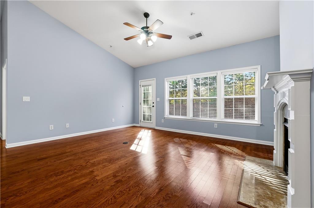 2310 Callaway Court Cumming, GA 30041 - Photo 12 of 30 a view of an empty room with wooden floor and a window