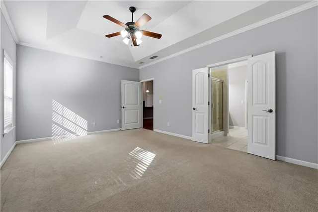an empty room with a ceiling fan and a window