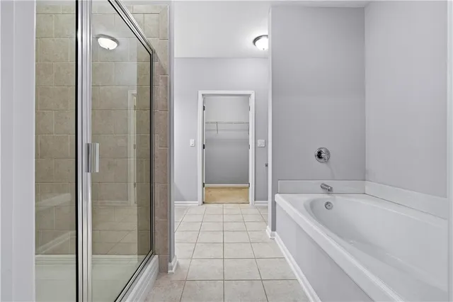 a bathroom with a bathtub and shower
