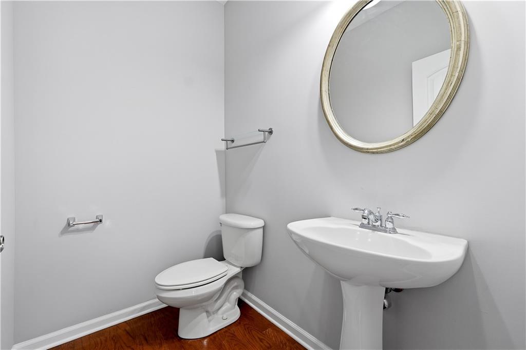 2310 Callaway Court Cumming, GA 30041 - Photo 20 of 30 a bathroom with a sink a mirror and a toilet