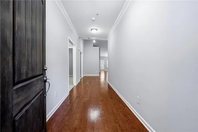 a view of hallway with wooden floor