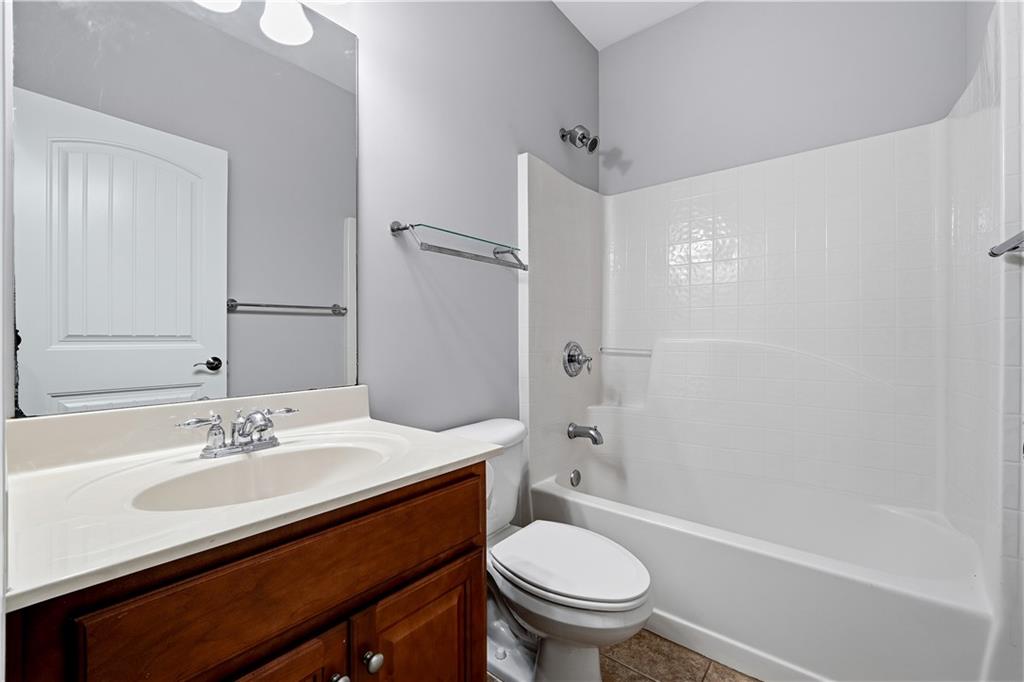 2310 Callaway Court Cumming, GA 30041 - Photo 23 of 30 a bathroom with a sink toilet and shower