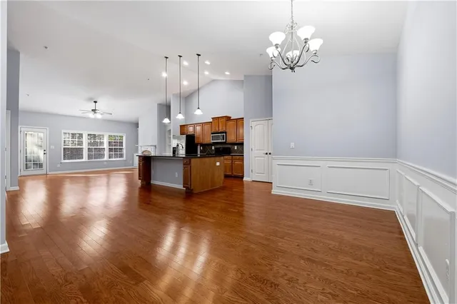 a view of a kitchen with a kitchen island wooden floor and a window