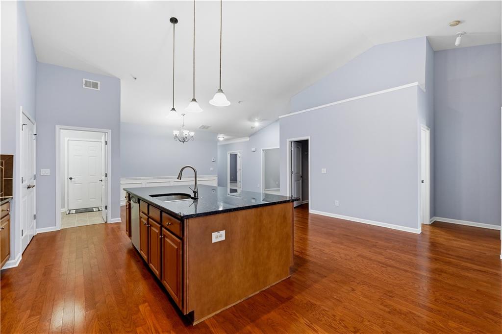 2310 Callaway Court Cumming, GA 30041 - Photo 7 of 30 a view of kitchen island with wooden floor