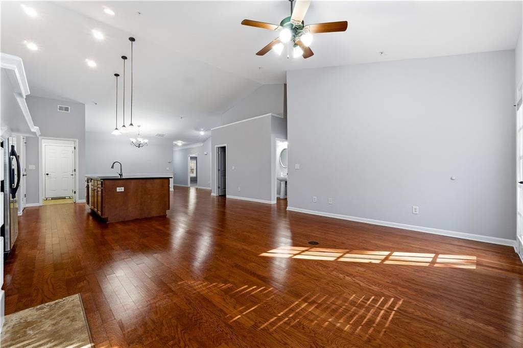 2310 Callaway Court Cumming, GA 30041 - Photo 10 of 30 a view of a livingroom with wooden floor and a ceiling fan