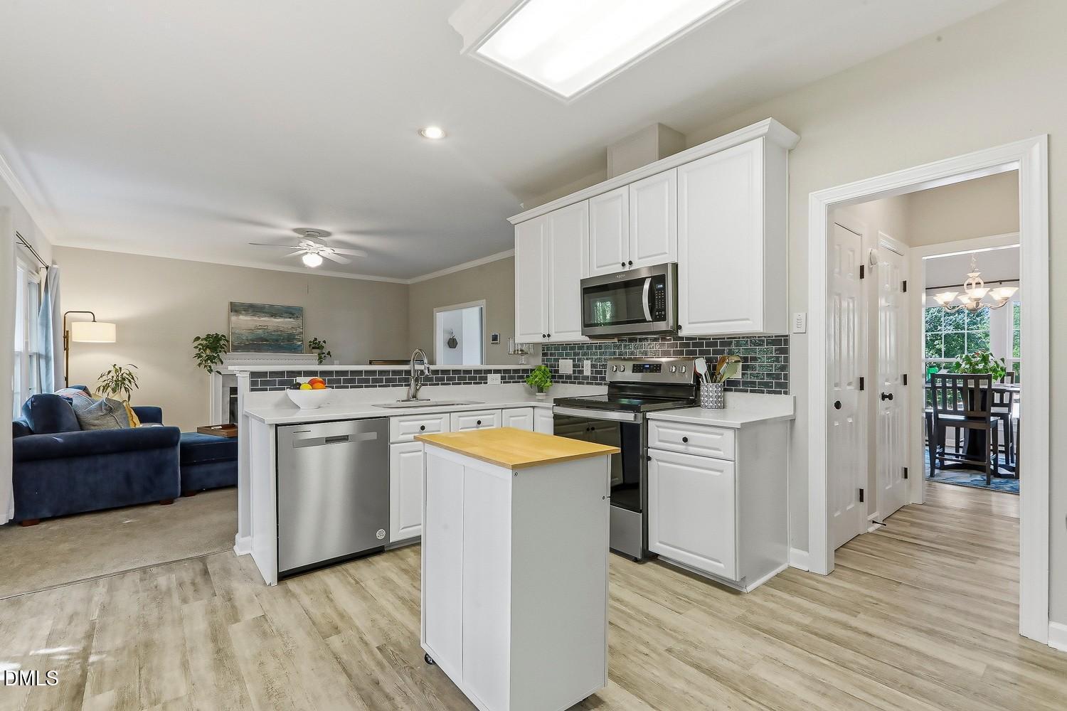 4001 Batiste Road Raleigh, NC 27613 - Photo 18 of 63 a kitchen with granite countertop appliances a sink and a refrigerator