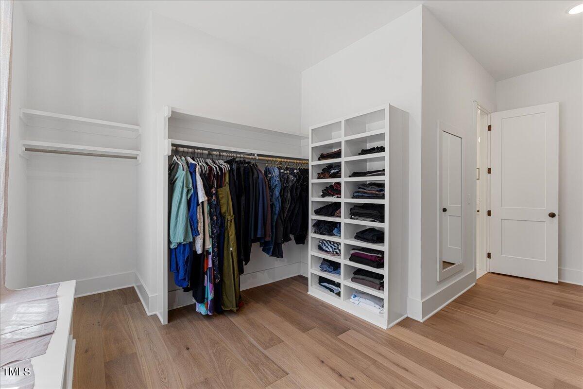 8420 Bells Lake Road Apex, NC 27539 - Photo 20 of 65 a view of walk in closet with clothes and shoes