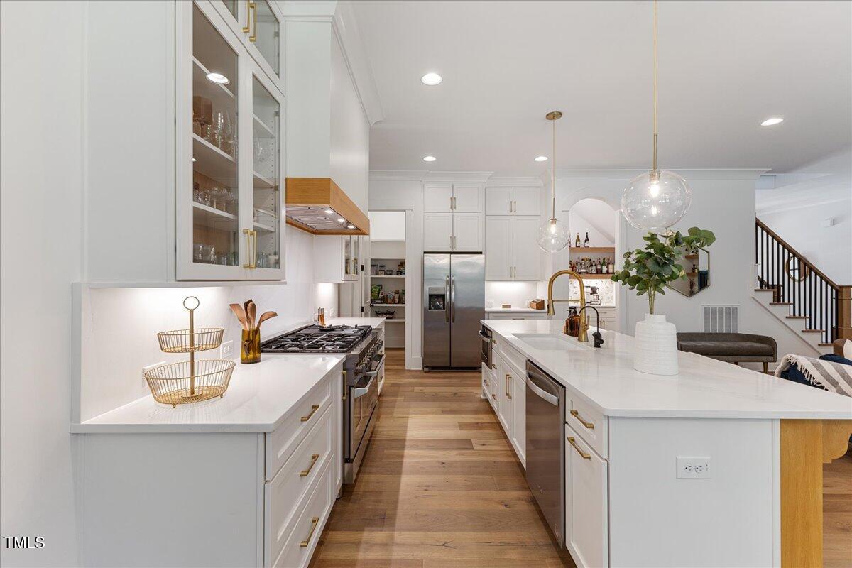 8420 Bells Lake Road Apex, NC 27539 - Photo 26 of 65 a kitchen with stainless steel appliances a sink stove and cabinets