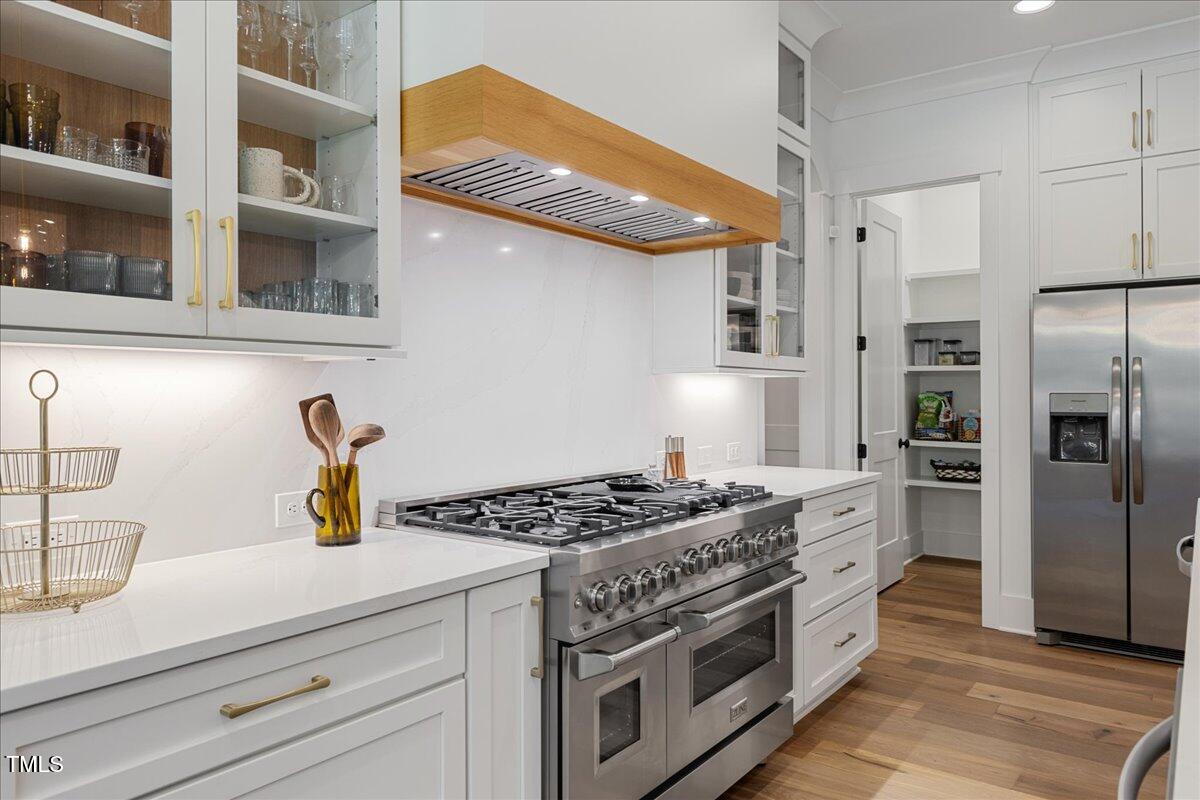8420 Bells Lake Road Apex, NC 27539 - Photo 27 of 65 a kitchen with stainless steel appliances granite countertop a stove and a refrigerator