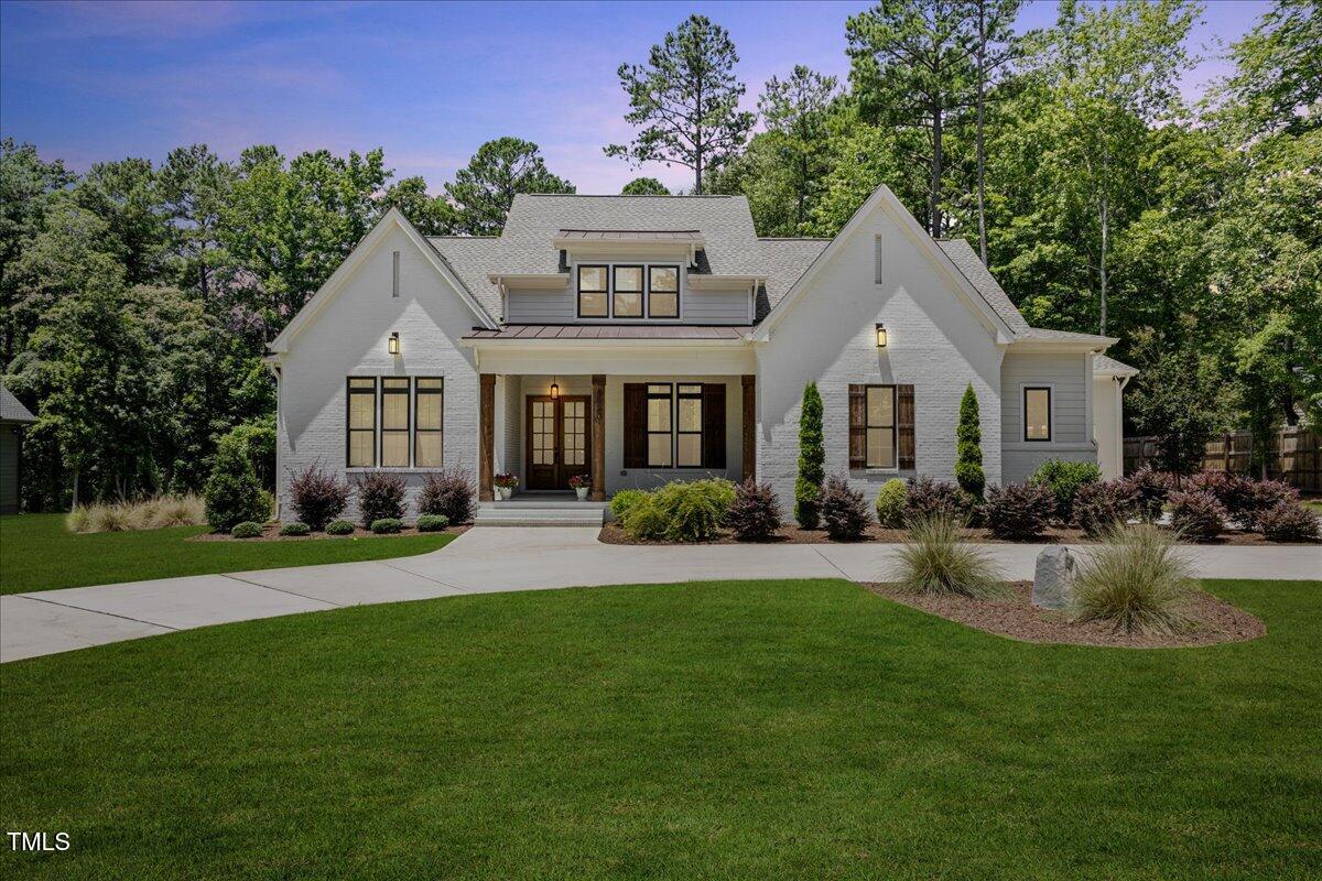 8420 Bells Lake Road Apex, NC 27539 - Photo 3 of 65 a front view of a house with garden and porch