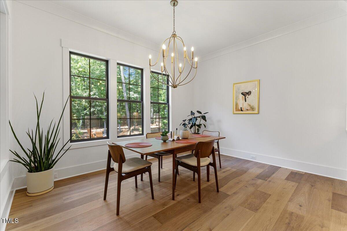 8420 Bells Lake Road Apex, NC 27539 - Photo 33 of 65 a view of a dining room with furniture window and wooden floor