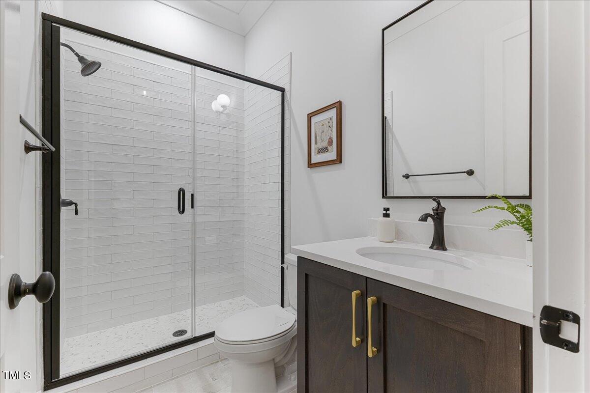 8420 Bells Lake Road Apex, NC 27539 - Photo 37 of 65 a bathroom with a sink toilet and shower