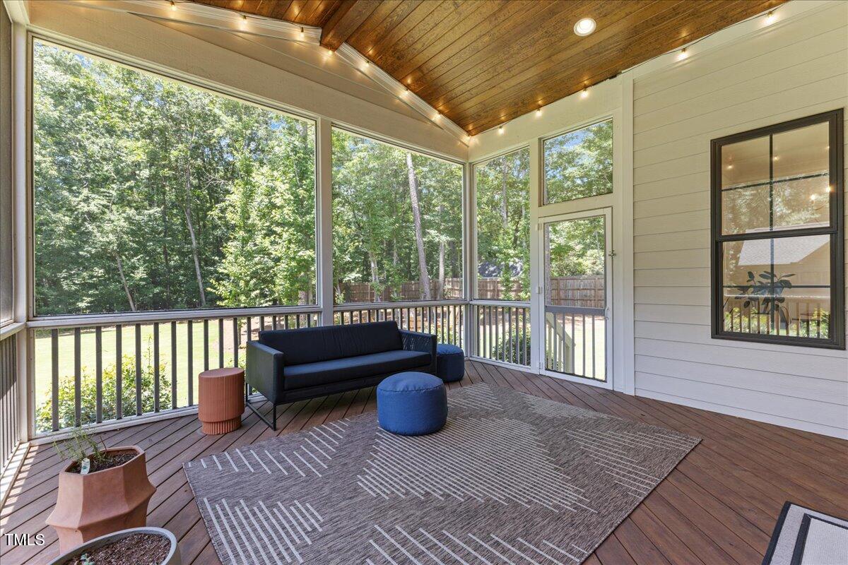 8420 Bells Lake Road Apex, NC 27539 - Photo 41 of 65 a living room with furniture tv and a large window