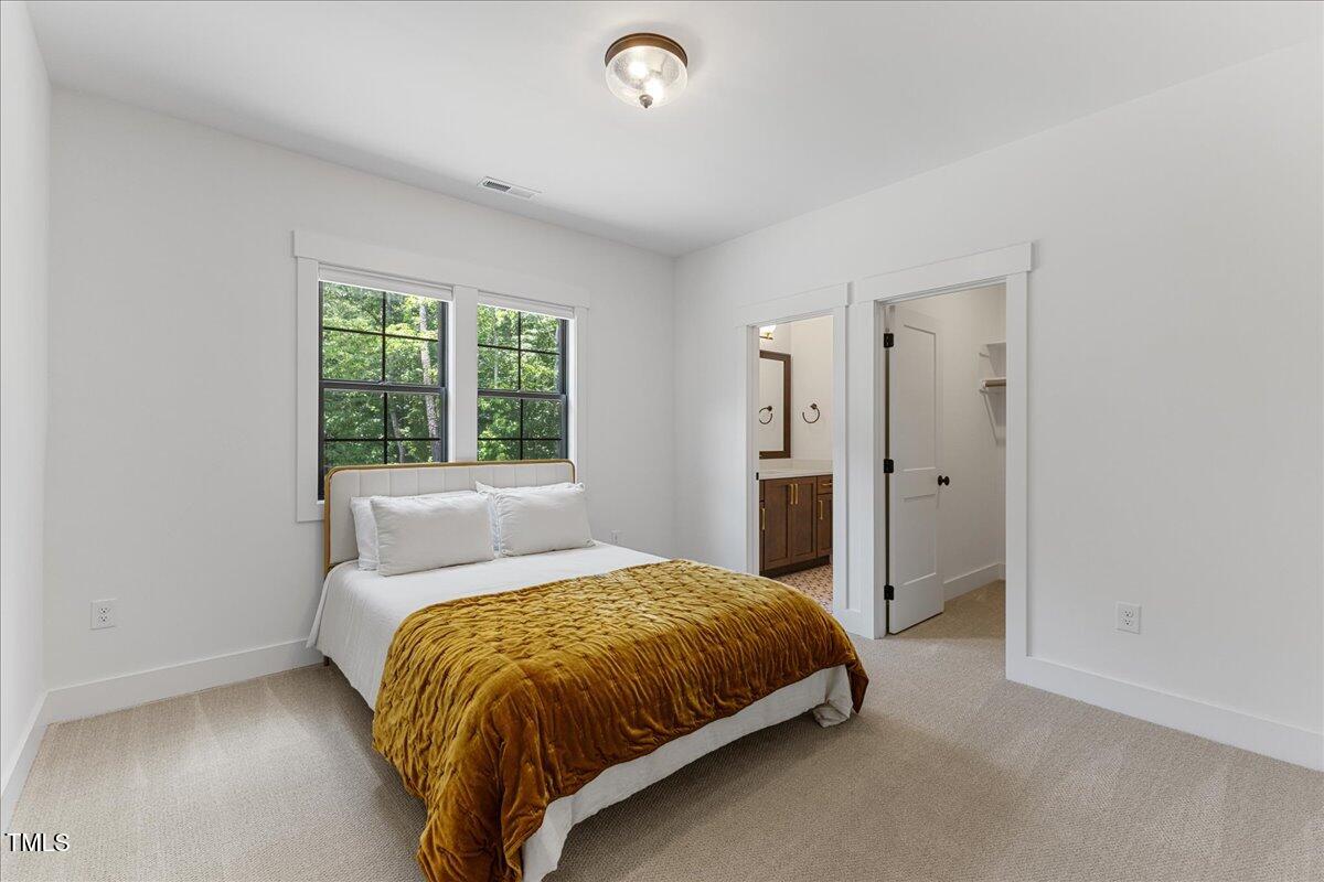 8420 Bells Lake Road Apex, NC 27539 - Photo 53 of 65 a bedroom with a bed and window