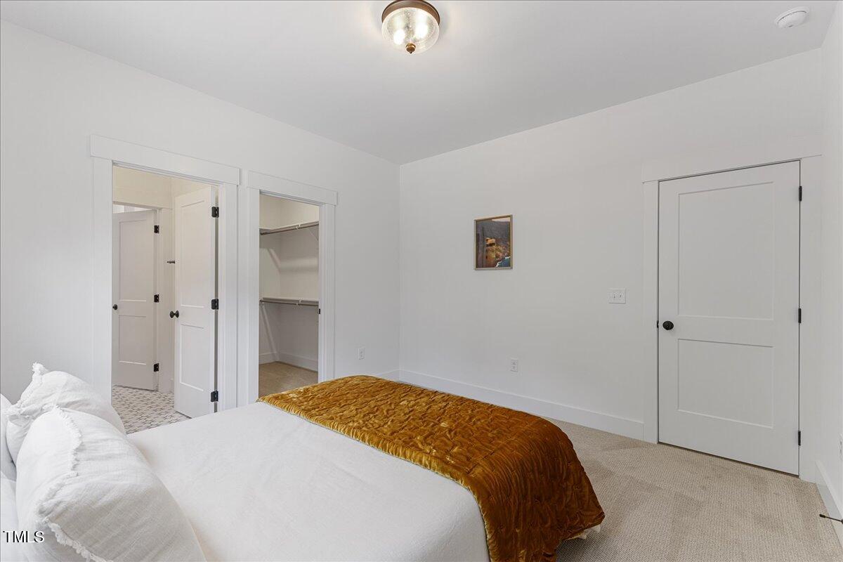 8420 Bells Lake Road Apex, NC 27539 - Photo 54 of 65 a bedroom with a bed and a cabinets