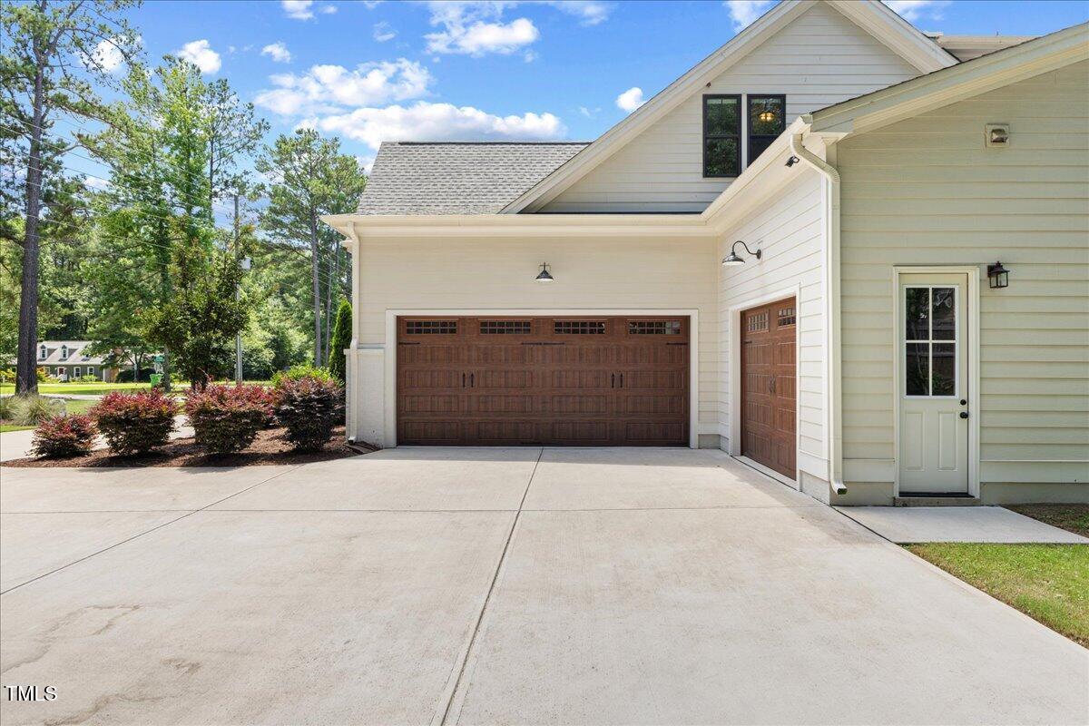 8420 Bells Lake Road Apex, NC 27539 - Photo 62 of 65 a front view of a house with garage