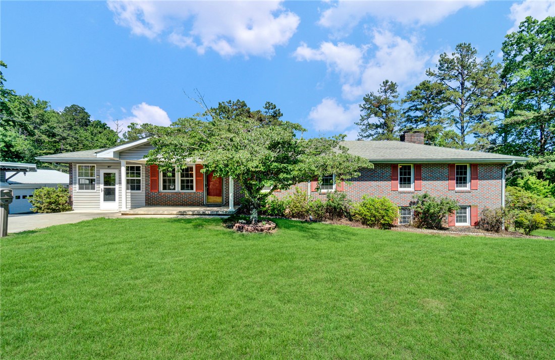 7876 Highway 11 Walhalla, SC 29691 - Photo 1 of 35 A classic brick and siding home with a generous front yard, offering a welcoming façade and mature landscaping.