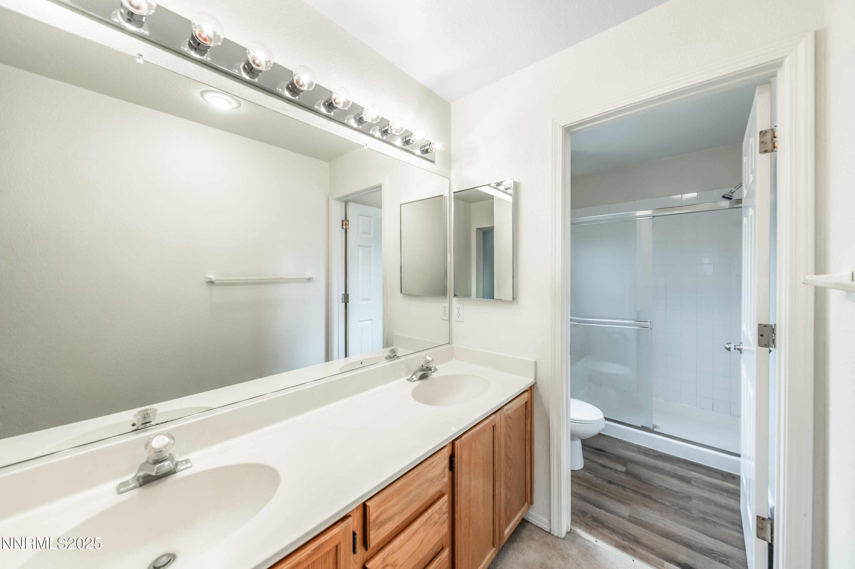 3188 Rose Vista Drive Reno, NV 89502 - Photo 22 of 30 a bathroom with a double vanity sink mirror and shower