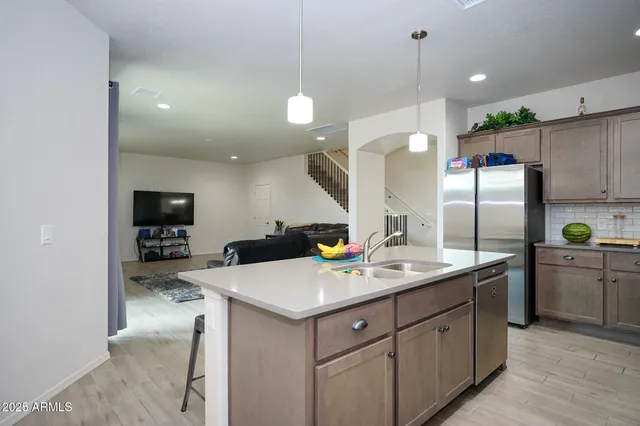a kitchen with a sink stainless steel appliances and cabinets