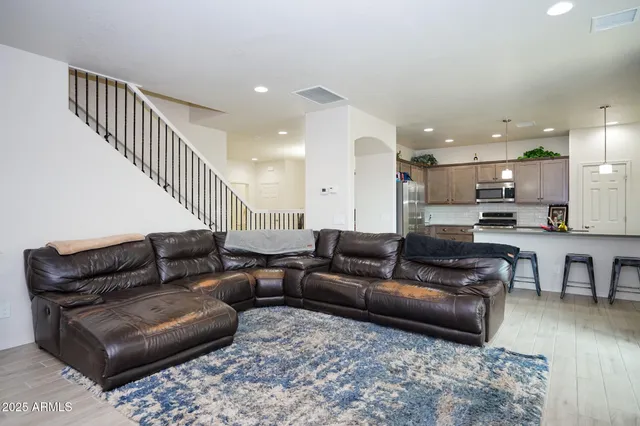 a living room with furniture or kitchen view and a wooden floor