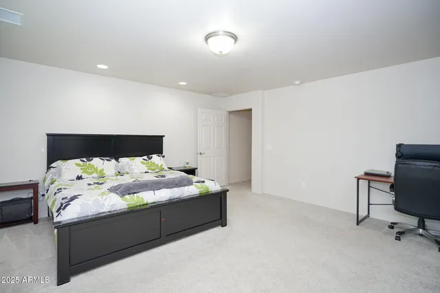 a bedroom with a bed and a chair