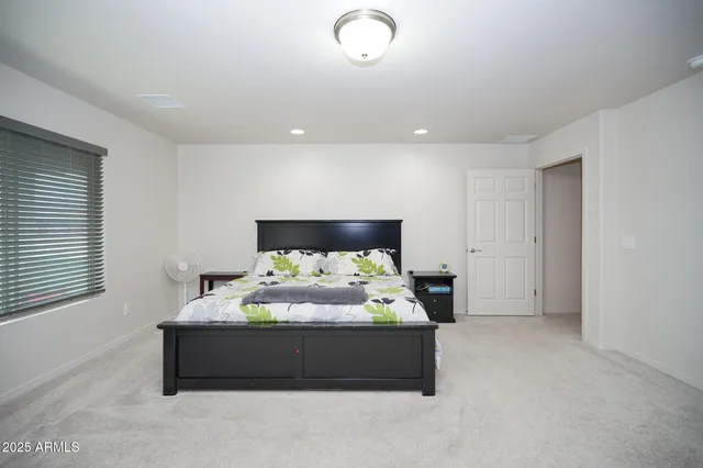 a bedroom with bed and window