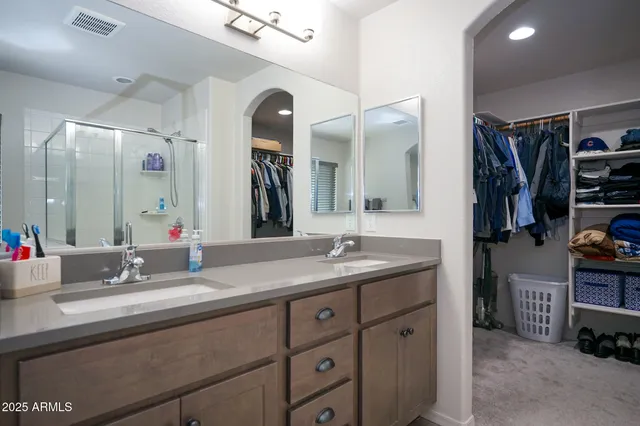 a bathroom with a double vanity sink and a mirror