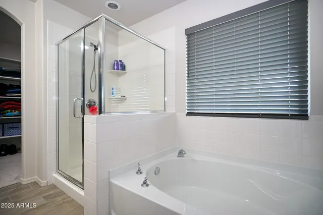 a bathroom with a bathtub and a shower
