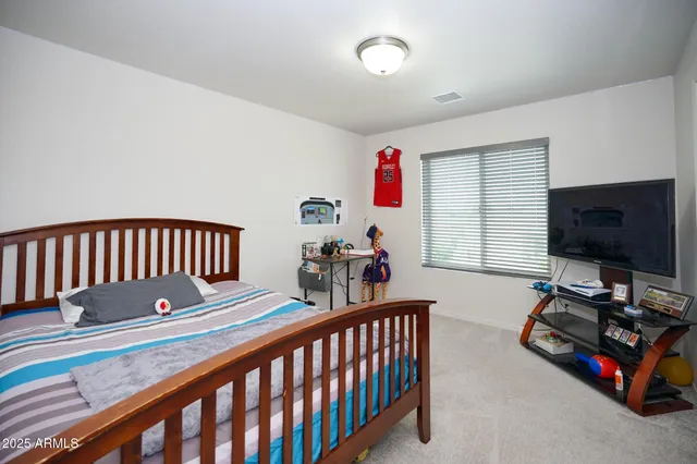 a bedroom with furniture and a window