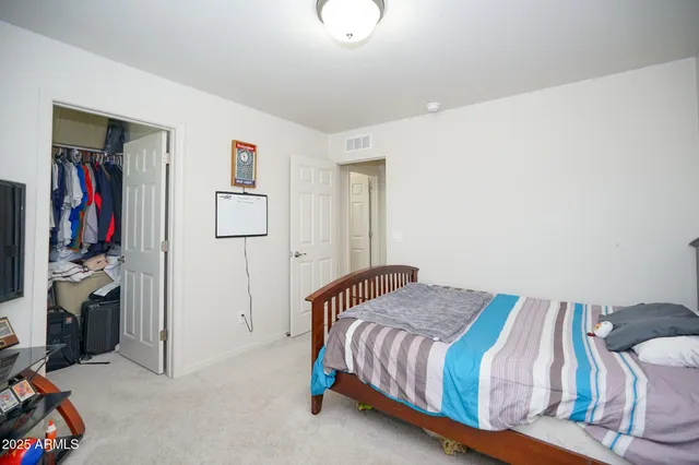 a bedroom with a bed and a walk in closet