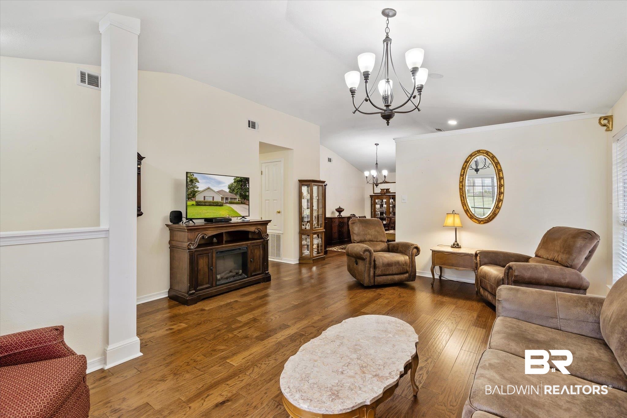 7236 Highpointe Place East Daphne, AL 36527 - Photo 4 of 32 Living room featuring vaulted ceiling, a chandelier, and hardwood / wood-style flooring