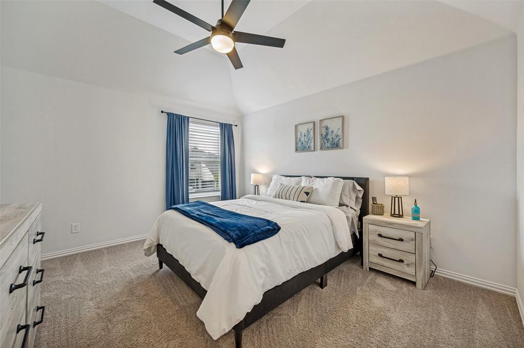 808 Violet Way Celina, TX 75009 - Photo 15 of 30 Upstairs bedroom featuring lofted ceiling and a ceiling fan
