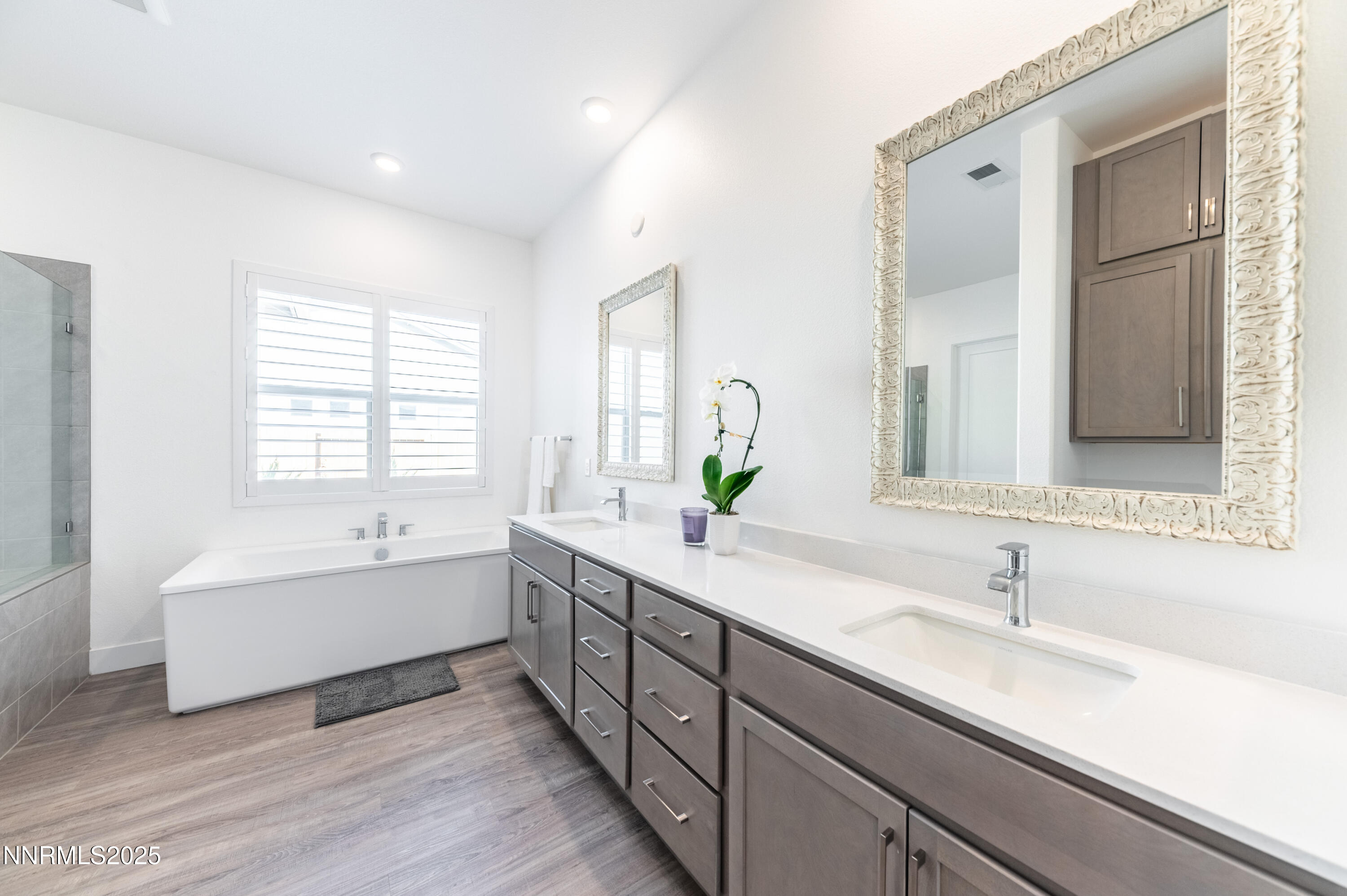 11640 Crosby Rnch Drive Sparks, NV 89441 - Photo 12 of 21 a bathroom with a double vanity sink bathtub and next to a window