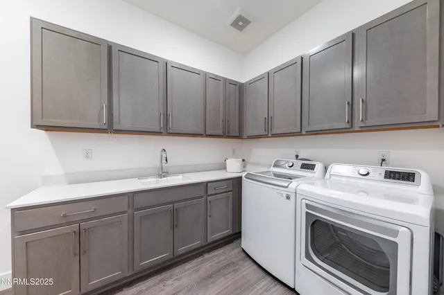 a view of a storage and utility room with cabinets