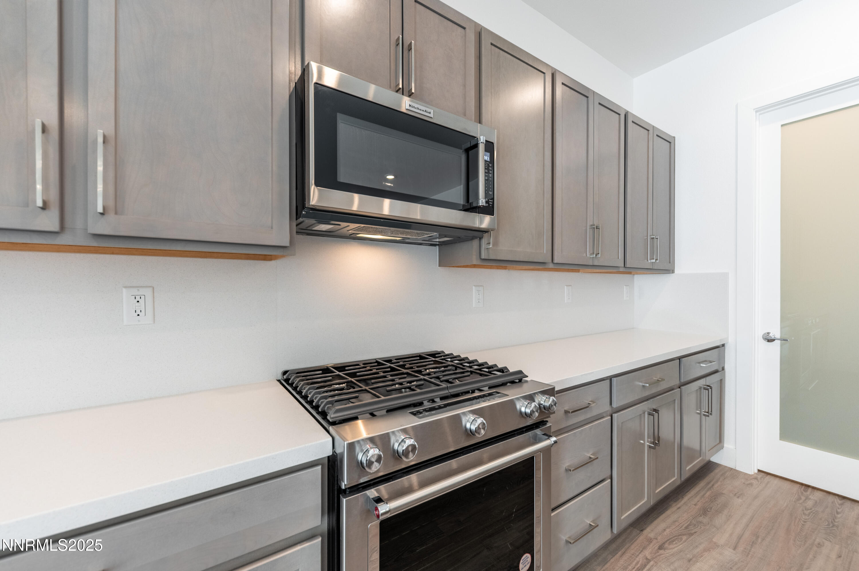 11640 Crosby Rnch Drive Sparks, NV 89441 - Photo 9 of 21 a kitchen with stainless steel appliances a stove a microwave and cabinets