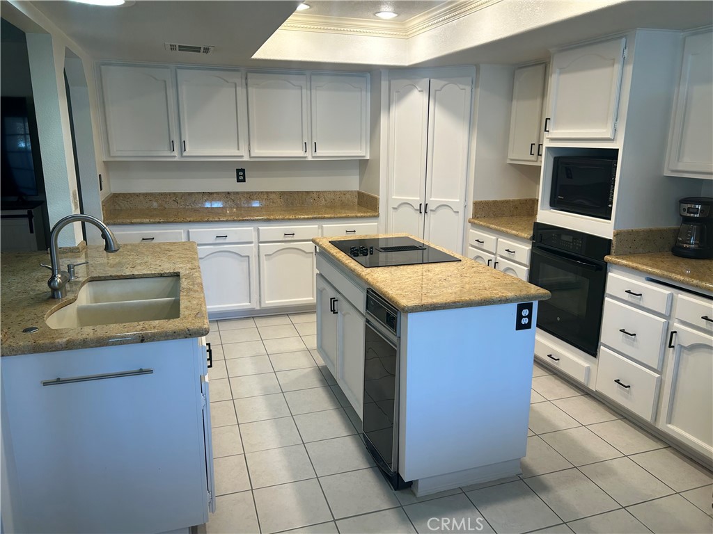 20187 Itasca Road Apple Valley, CA 92308 - Photo 21 of 35 a kitchen with a stove sink and cabinets