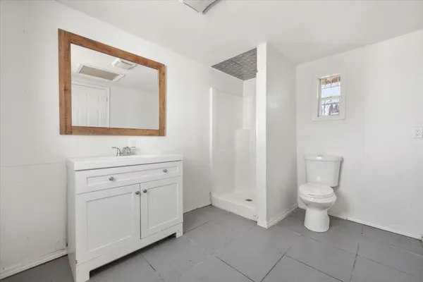 a bathroom with a toilet sink and mirror